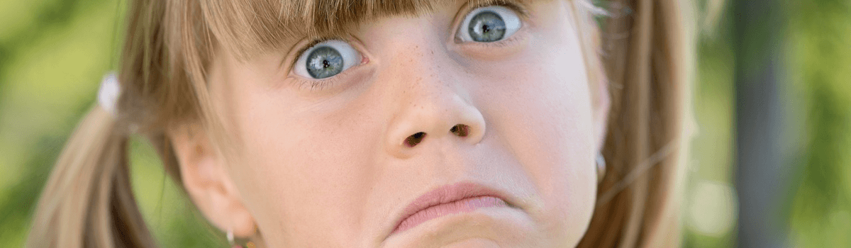 Close-up of a young girls face who is overwhelmed.