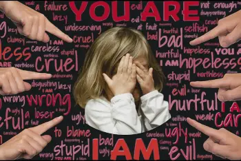 Black background with multiple words and sayings that are common accusations against a scapegoated child. A little girl is in a circle in the center with her hands covering her faces. Hands point at her accusingly.